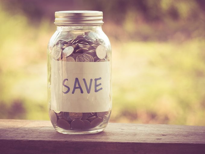 Investing, a jar of coins with the word Save written across