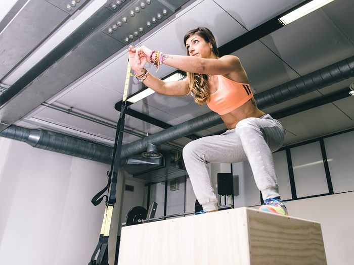 Jillian Michaels, woman at gym jumping on box
