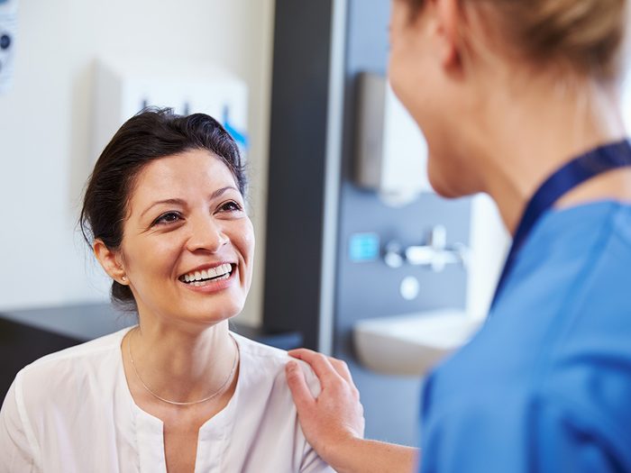 Genetic testing, A happy patient smiles at a nurse who rubs her shoulder