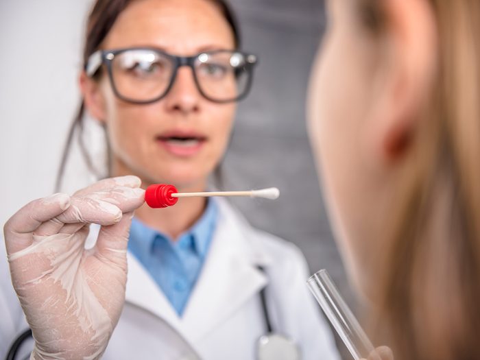 Genetic testing, Doctor swabs woman's mouth