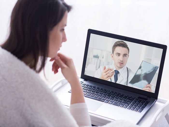 Genetic testing, Woman speaks to her doctor from home via computer