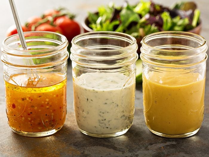 How to eat healthy, three open mason jars filled with various dressings and sauces