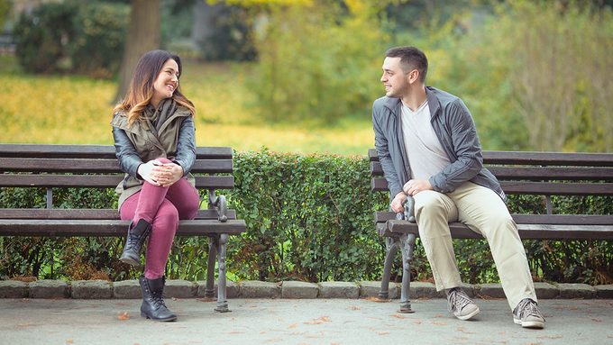 Love at first sight, man and woman on park bench