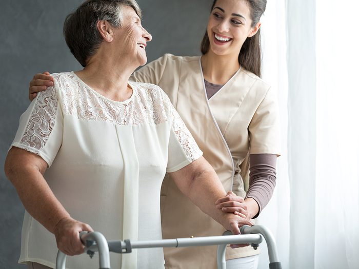Osteoporosis, elderly woman walks in hospital with a walker