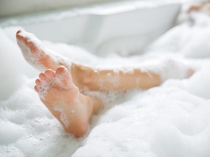 Self love, a woman's feet in a bubble bath