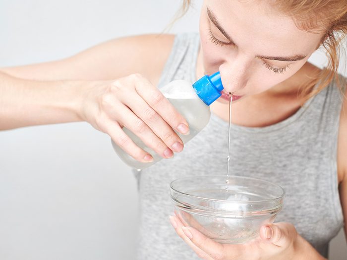 Allergies, woman rinses her nasal passage with saline rinse