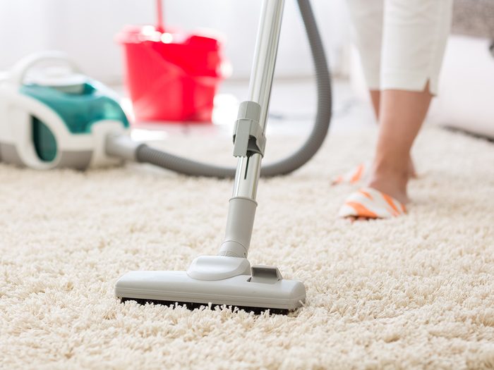 Allergies, woman vacuuming her carpet