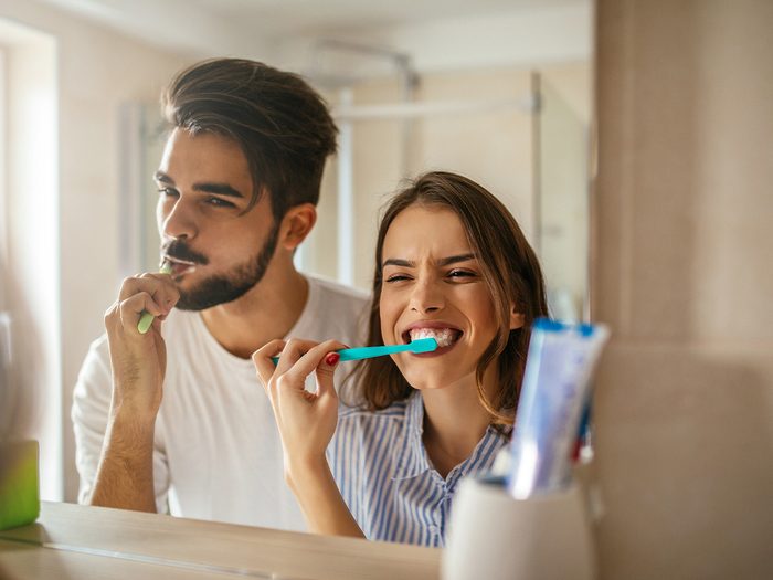 Extreme weight loss, a man and woman brush their teeth in the bathroom