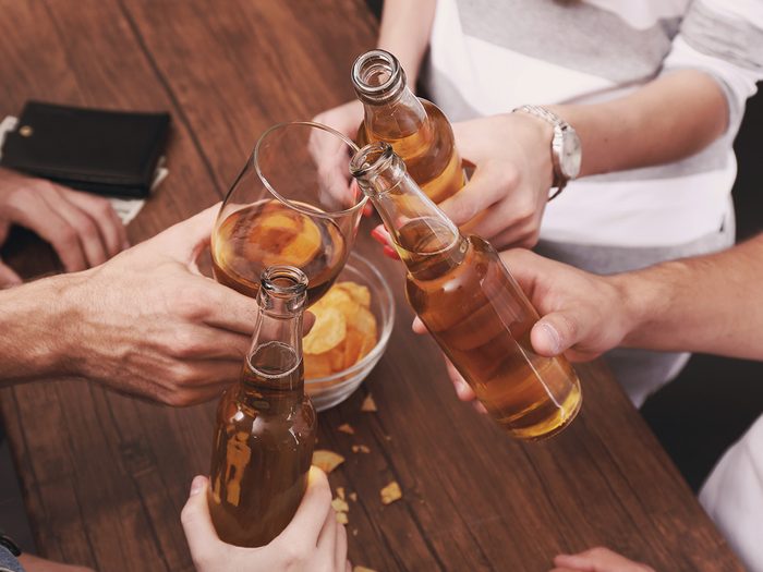 Extreme weight loss, friends drink beer at a bar and cheers