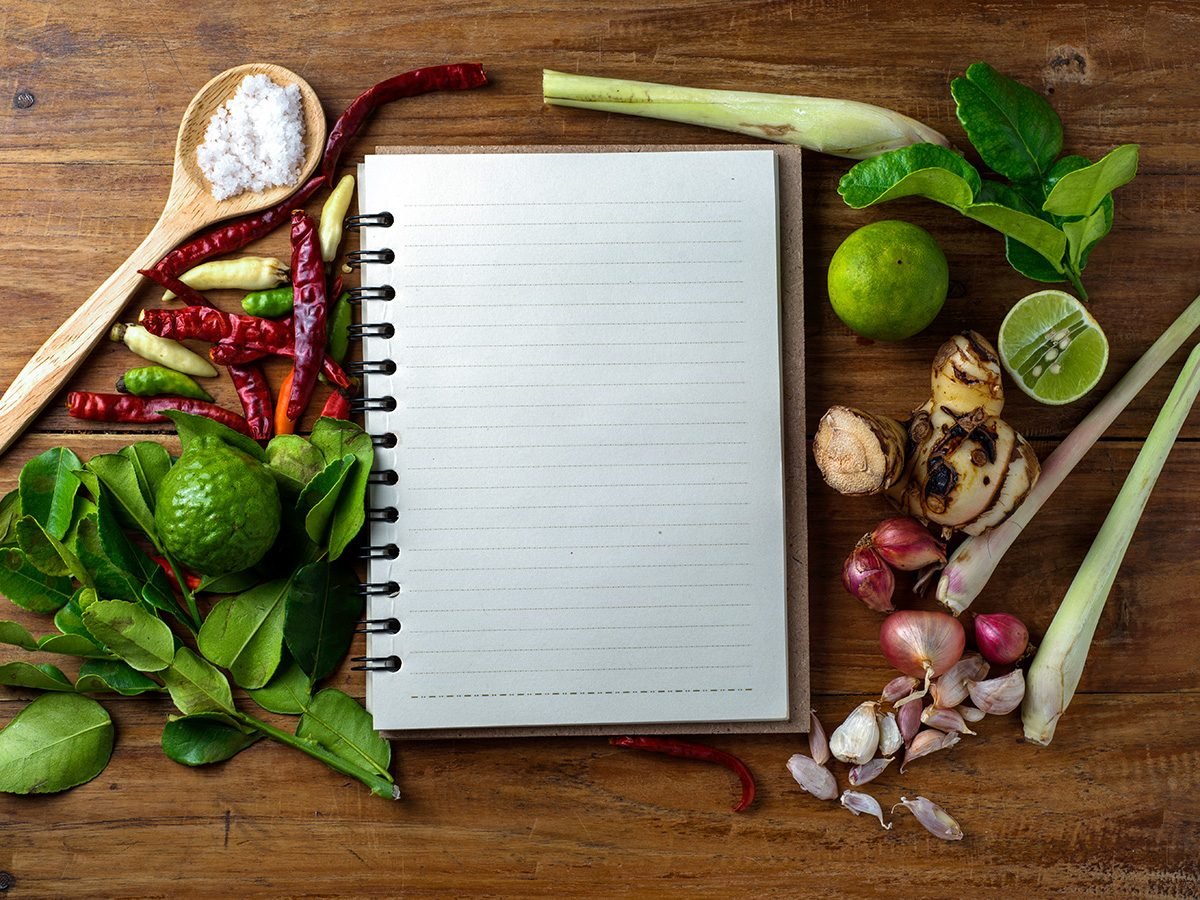 Extreme weight loss, a blank notebook surrounded by vegetables