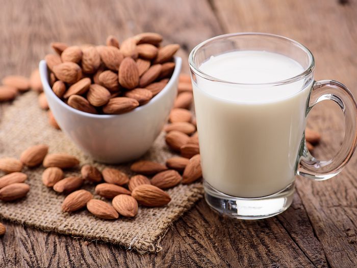 Healthy foods, a mug of almond milk next to a bowl of almonds