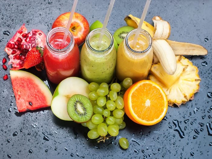 Healthy foods, cups of juice surrounded by fruit