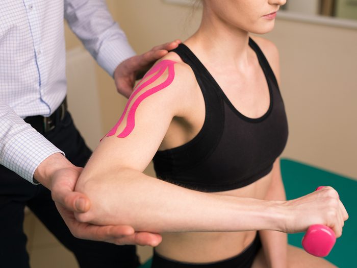 Muscle pain relief, woman getting physio for her shoulder