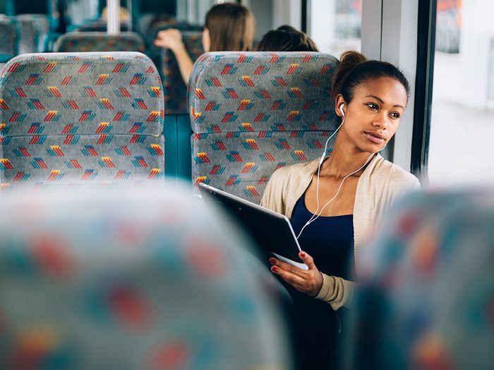 Self love, woman creates a mantra on the bus as she sits listening to music