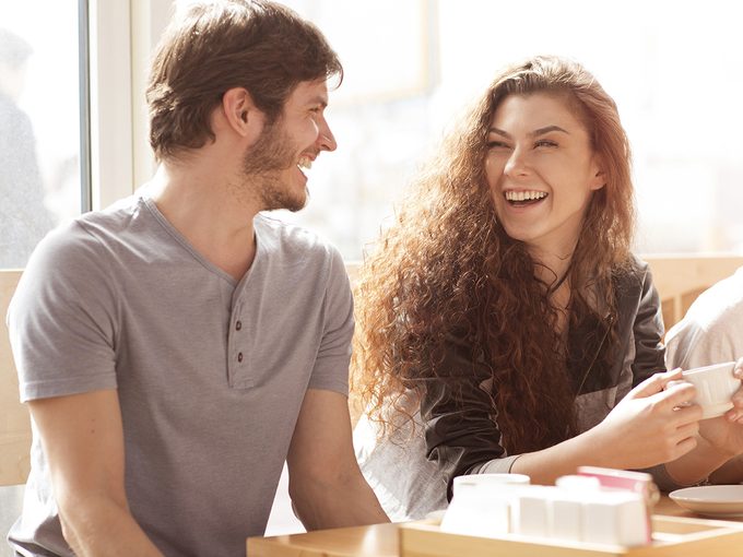 Sexual attraction, a young man and woman laughing together