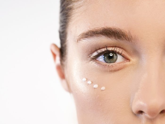 Skin, woman with eye cream dotted under her eyes
