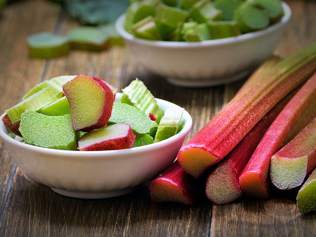 Superfoods, bowl of cut up rhubarb with rhubarb stocks lying next to it