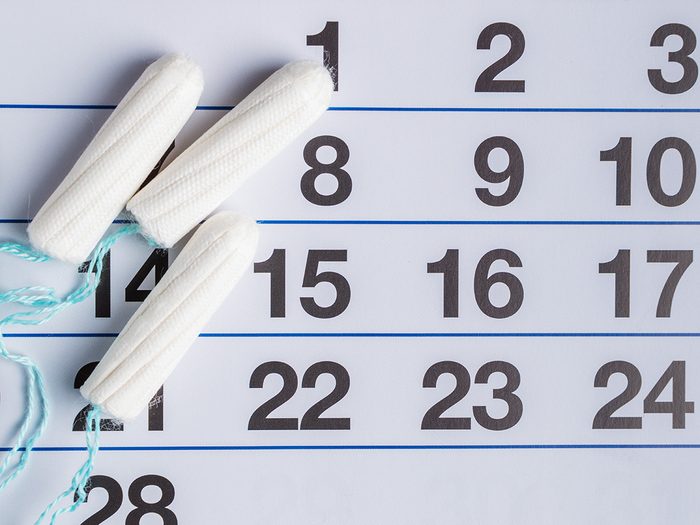 Weight gain, tampons on a calendar to signify an irregular period