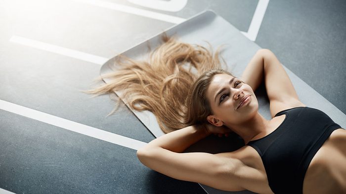 Gym Beauty Essentials, woman lying on gym floor