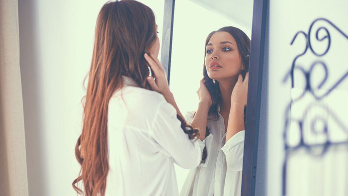 Relationship, woman looking in mirror