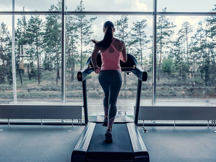 Woman completing a run on a treadmill