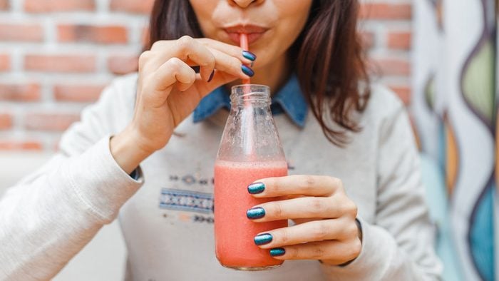 woman sipping a smoothie for blood type diet
