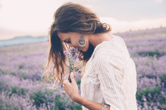 health benefits of terpenes woman smelling lavender in a field