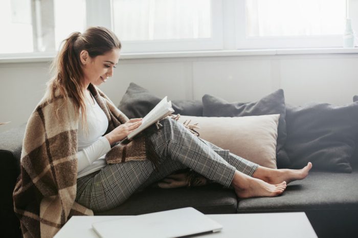 cozy woman relaxing with a book