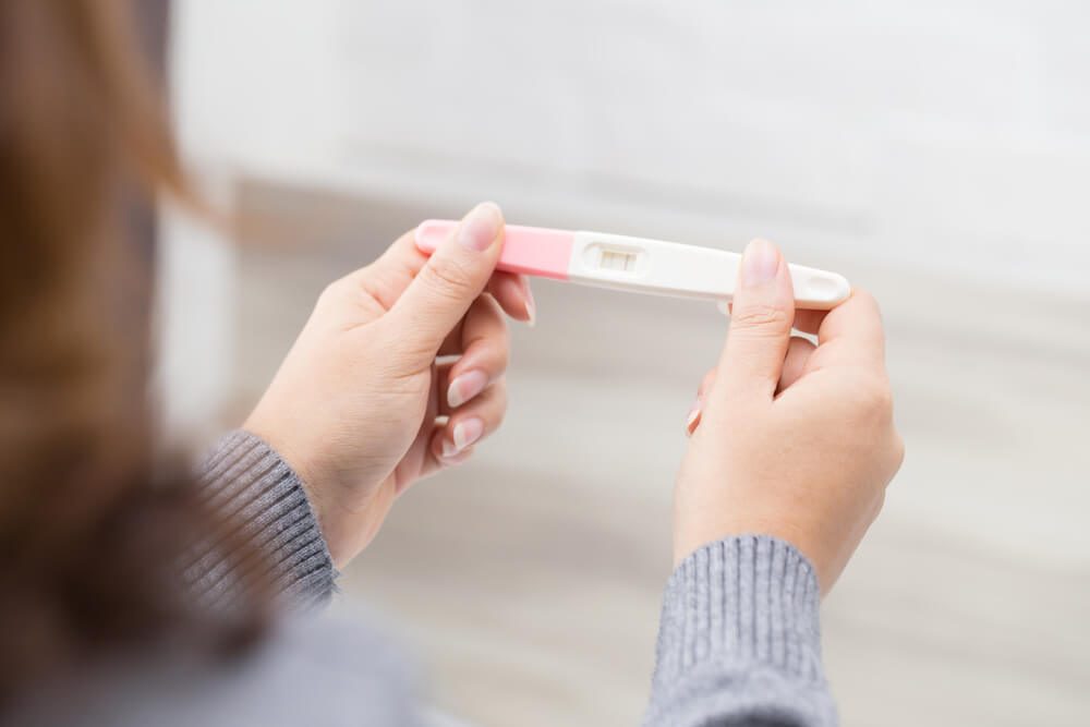 Woman holding pregnancy test, New life and new family concept.