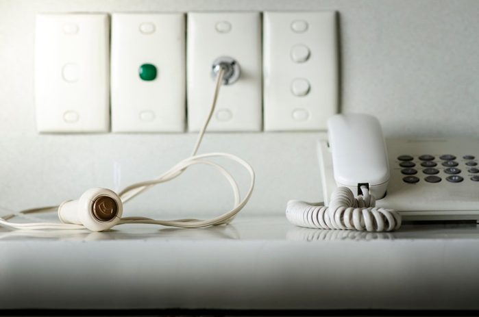 Nurse Call System on wall white background. Call Cord Switch whit Phone on table in hospital. telephone and Call Cord Switch on table in hospital.