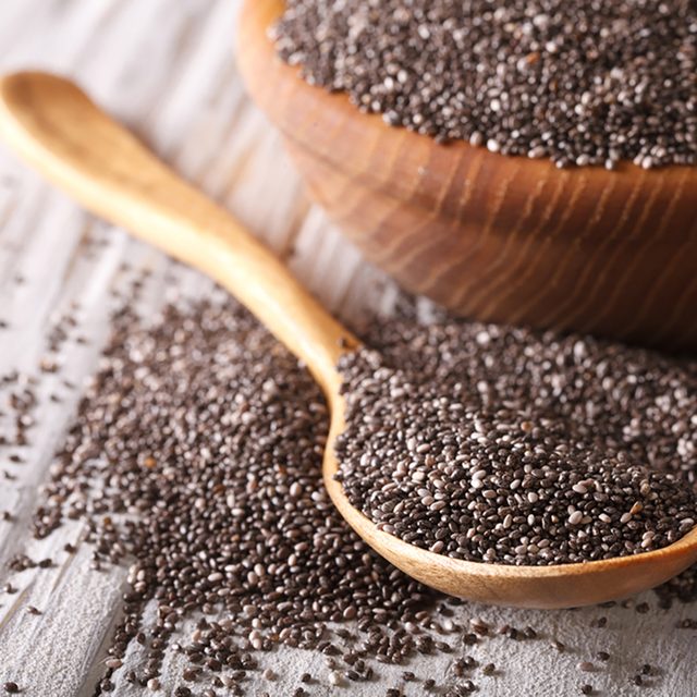 Healthy Chia seeds in a wooden spoon on the table close-up. horizontal