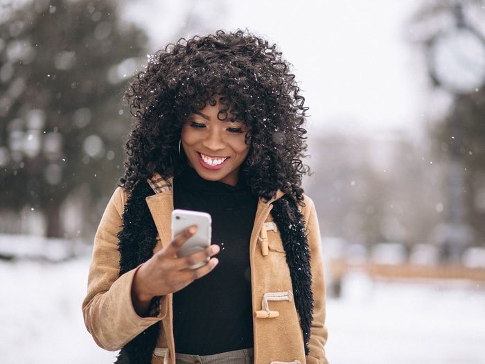 woman with phone in winter