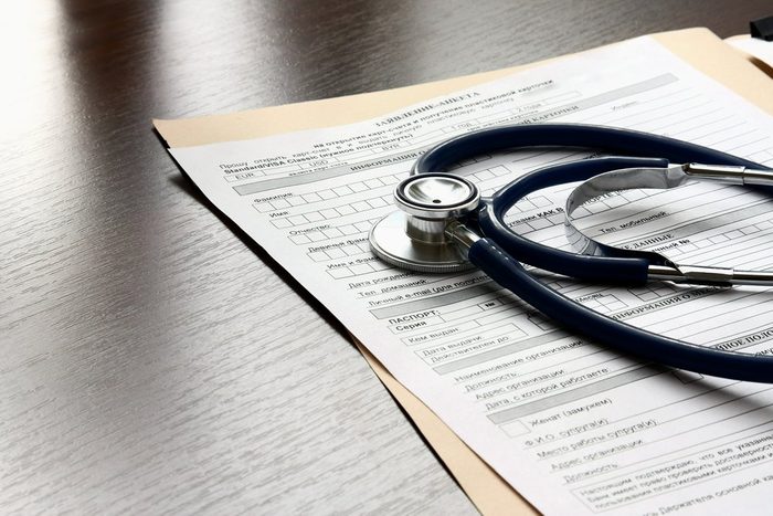 Stethoscope on medical billing statement on table, all text is anonymous