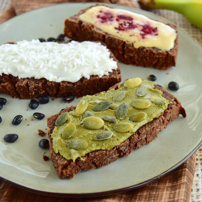 Sliced black bean bread with spread and topping