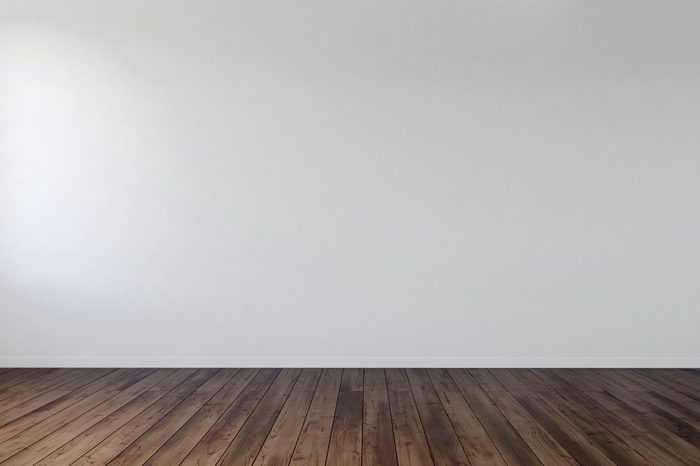 Empty unfurnished bare room interior with white wall and wood floorboards in an architectural background. 3d Rendering.