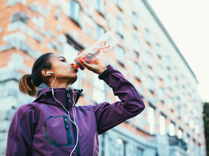 woman running drinking water sport
