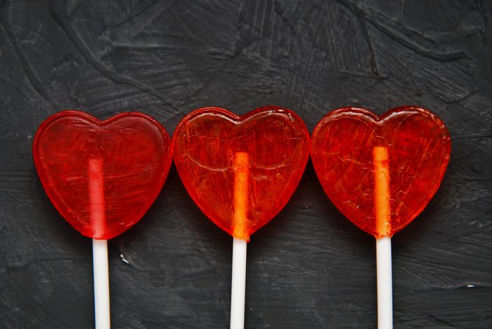 Colorful lollipops Heart Shape on dark background. Top view. Love and Valentine's Day Concept.