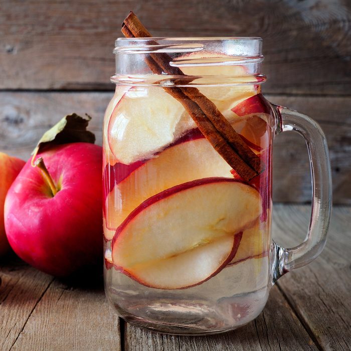 Autumn themed detox water with apple, cinnamon and red pear in a mason jar on a rustic wood background; Shutterstock ID 474961468; Job (TFH, TOH, RD, BNB, CWM, CM): Taste of Home