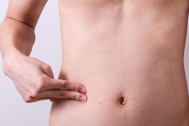 man finger push at belly or appendix