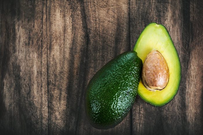 Food background with fresh organic avocado 