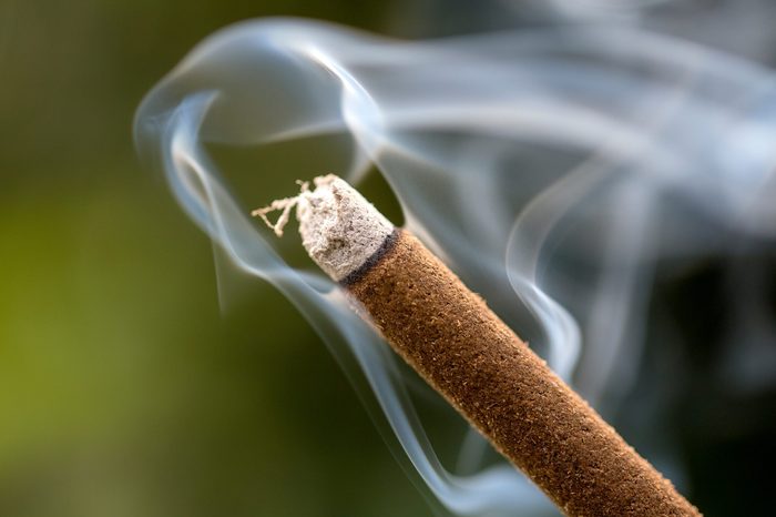 Incense stick burning with smoke, close up, macro. Island Bali, Ubud, Indonesia