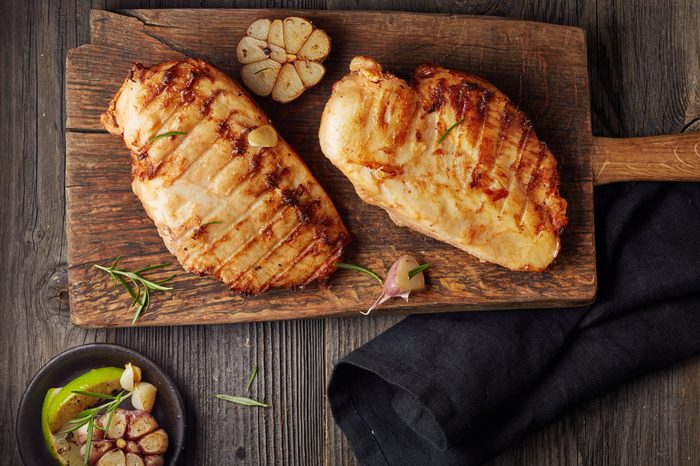 Grilled chicken fillet on wooden cutting board