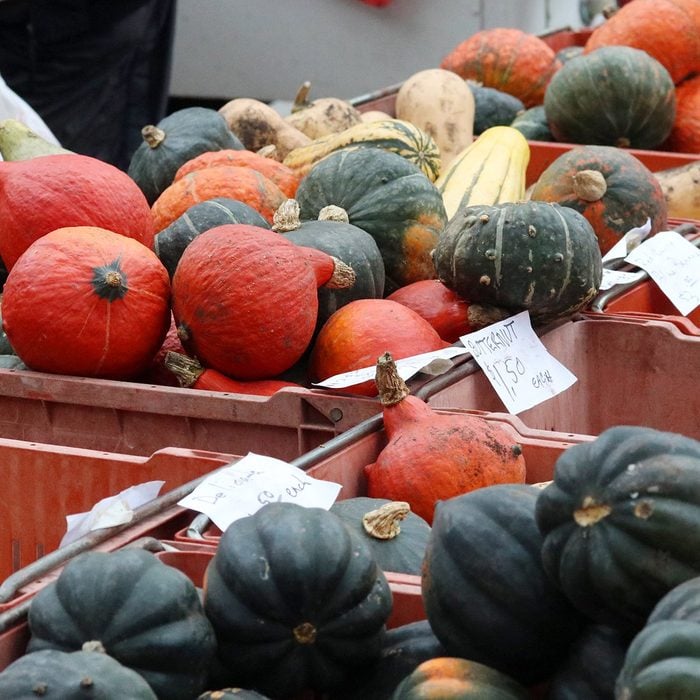 Farmers market goods display. Colorful winter squashes for sale in boxes at the autumn seasonal farmers market. Agriculture, farming and small business background. Harvest concept.; Shutterstock ID 1128537929; Job (TFH, TOH, RD, BNB, CWM, CM): TOH