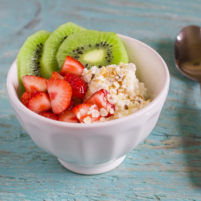 cottage cheese with strawberries, kiwi, honey, cereals and seeds of flax