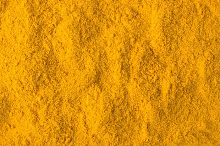 texture of turmeric powder close-up, spice or seasoning as background