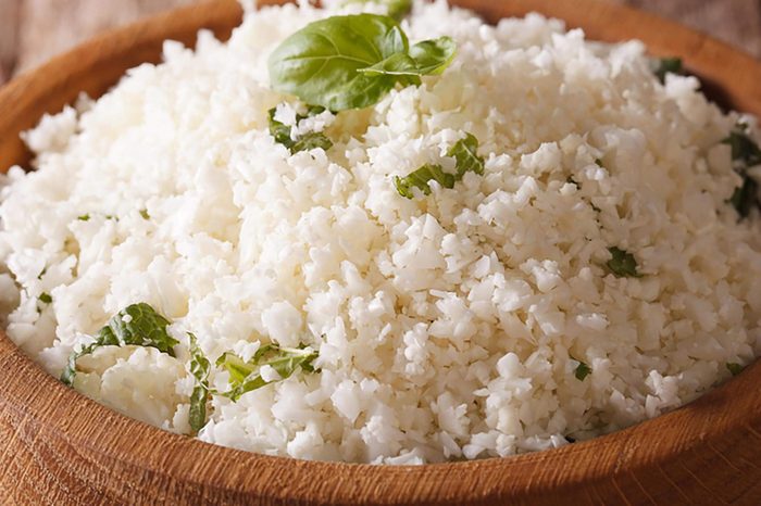 Paleo Food: Cauliflower rice with herbs close-up in the bowl. horizontal