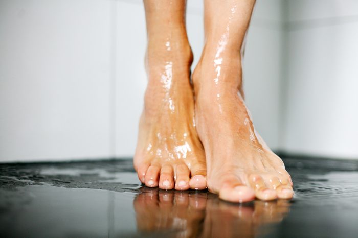 Beautiful female feet under the shower