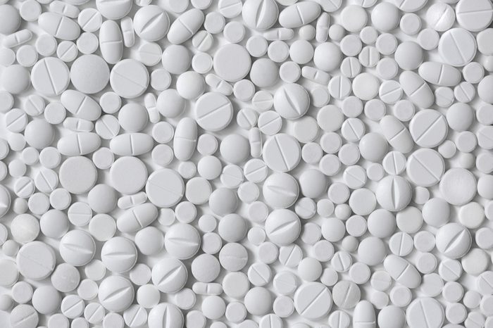 White pills, white background, different shapes and sizes