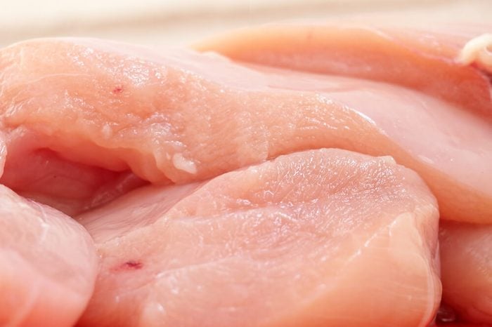 Raw chicken fillets close-up / partially out of focus, focus on the center of the image 