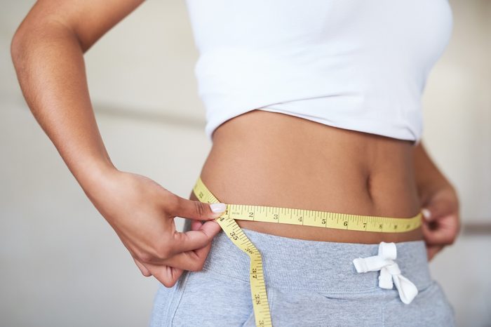 Gluten-free Diet | Celiac Disease | Gluten sensitivity | Gluten Intolerance | Woman measuring her waist in the bathroom